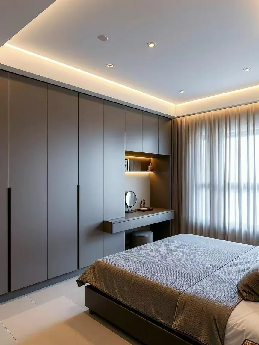 Custom floor-to-ceiling grey wardrobe system featuring integrated interior lighting and seamless architectural alignment.