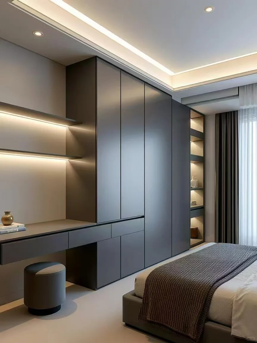 Modern minimalist grey wardrobe with integrated vanity desk and ambient LED lighting for contemporary bedroom suites.